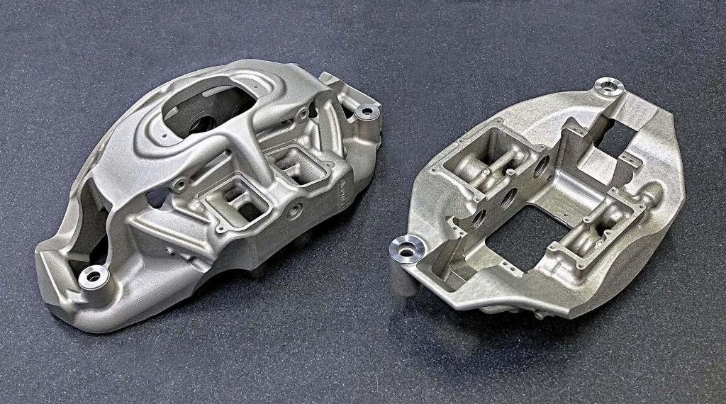 The top of a finish-machined front brake caliper (left) and the underside of a rear brake caliper for the hypercar produced on the third Hermle 5-axis machining cell installed at Alcon Components