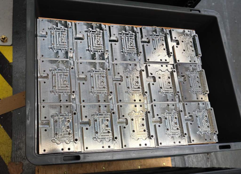 The machined aluminium components will form part of a barcode printer. Here they are pictured after Op 10, ready for a second, manually-attended machining operation to mill material from the sixth face