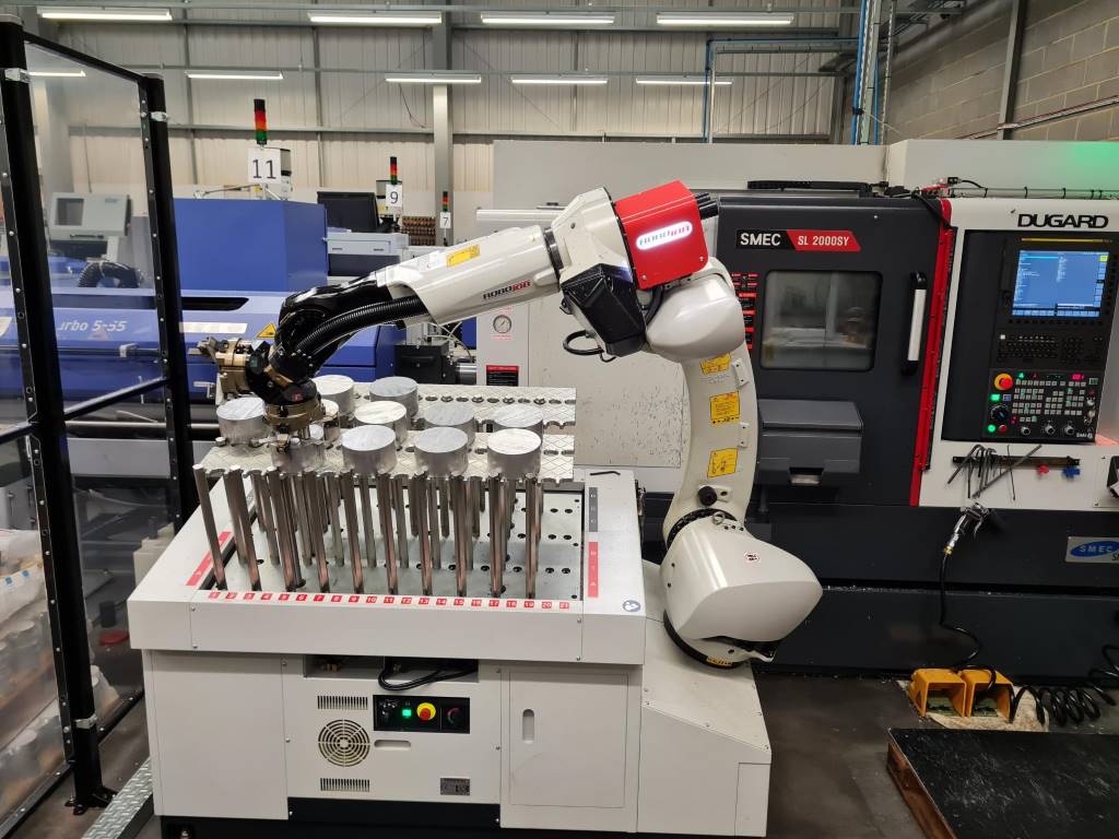 The robot picking a new billet for machining